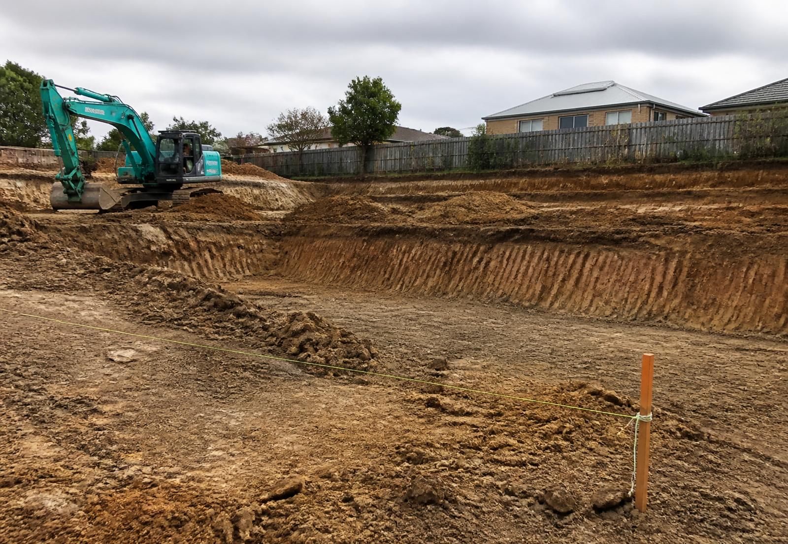 Excavated site with clean batters and a set-out string line
